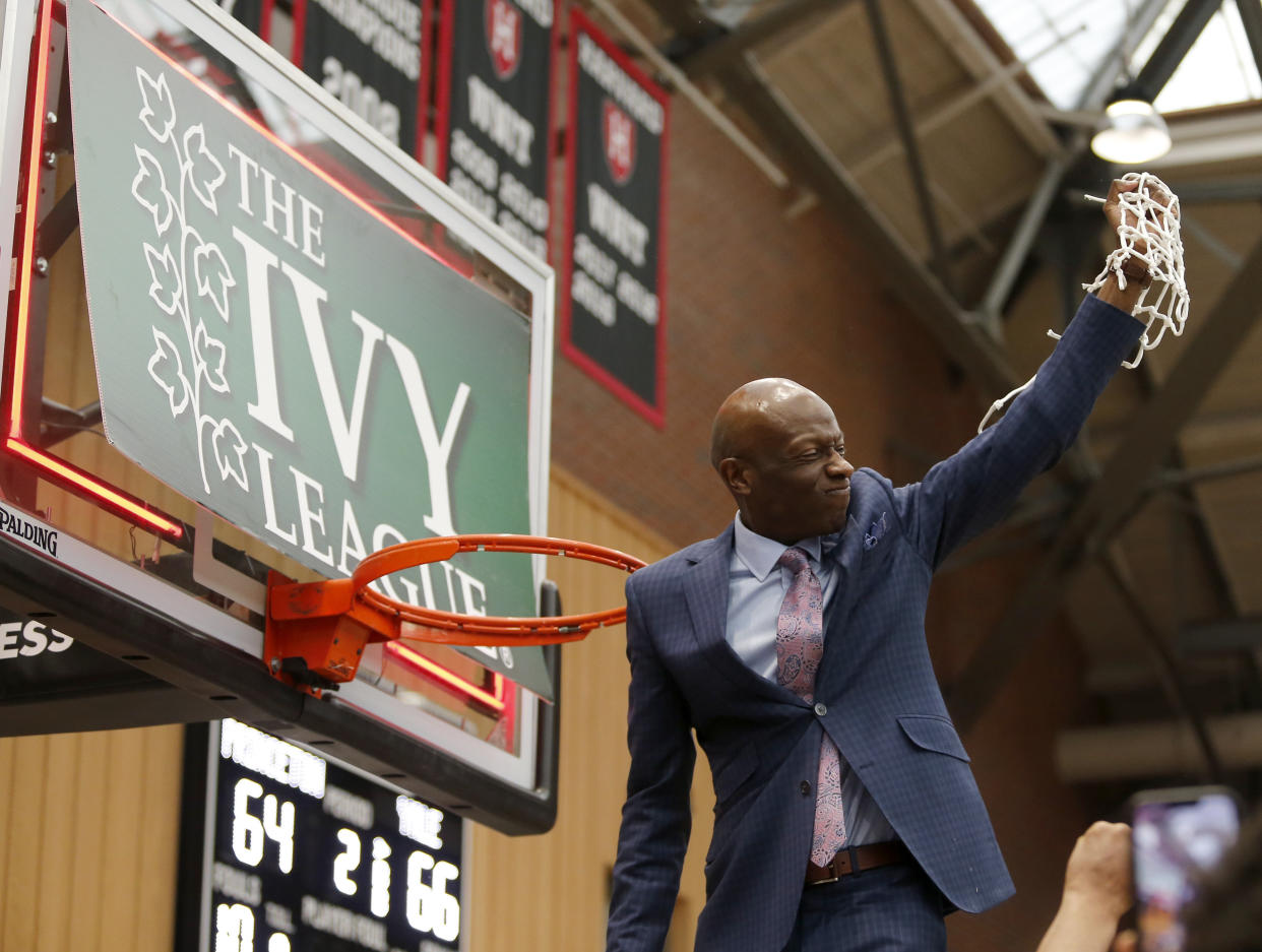 FILE - Yale head coach James Jones celebrates after cutting down the net after defeating Princeton in the NCAA Ivy League men's college basketball championship game, Sunday, March 13, 2022, in Cambridge, Mass.A federal lawsuit filed by a pair of basketball players from Brown University alleges the Ivy League’s policy of not offering athletic scholarships amounts to a price-fixing agreement that denies athletes proper financial aid and payment for their services. The lawsuit was filed Tuesday, March 7, 2023, in U.S. District Court in Connecticut. (AP Photo/Mary Schwalm, File)