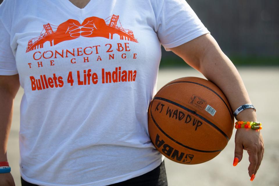 Loria Perez talks about losing her son Kelvin Stanford Jr. while holding a basketball he owned Wednesday, May 11, 2022 near her former home in South Bend. 