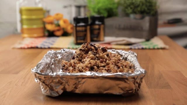 Granola mixture in lined aluminium baking tray
