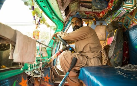 Jabbar, 45, poses for a portrait while seated inside his tanker at the Sakhi Hassan hydrant in Karachi on December 6, 2018. A father of five, he has been a tanker driver for the last five years, his daily earning is PKR 1,200. He buys a tanker of 1,000 for his family home every 8 days for PKR 1,000 each  - Credit: Insiya Syed/The Telegraph