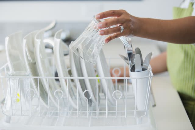 Sidekick / Getty Images Woman putting clean dishes into dish rack to dry