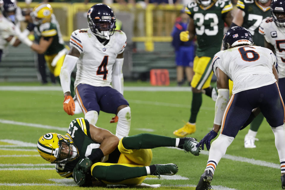Green Bay Packers wide receiver Allen Lazard (13) catches a 5-yard touchdown pass between Chicago Bears safety Eddie Jackson (4) and cornerback Kyler Gordon (6) during the first half of an NFL football game Sunday, Sept. 18, 2022, in Green Bay, Wis. (AP Photo/Mike Roemer)