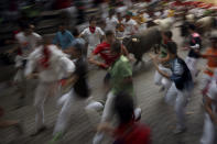 <p>Revelers run alongside the daily running of the bulls of the San Fermin festival in Pamplona, Spain, July 14, 2015. (Photo: Daniel Ochoa de Olza/AP) </p>