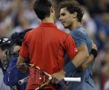 Rafael Nadal of Spain is congratulated by Novak Djokovic of Serbia (L) after his victory in their men's final match at the U.S. Open tennis championships in New York, September 9, 2013. REUTERS/Eduardo Munoz (UNITED STATES - Tags: SPORT TENNIS)