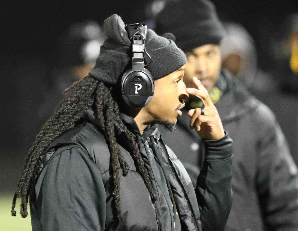 Taft head coach Tyler Williams talks with his players during their 14-0 playoff loss to Versailles, Saturday, Nov. 13, 2021.