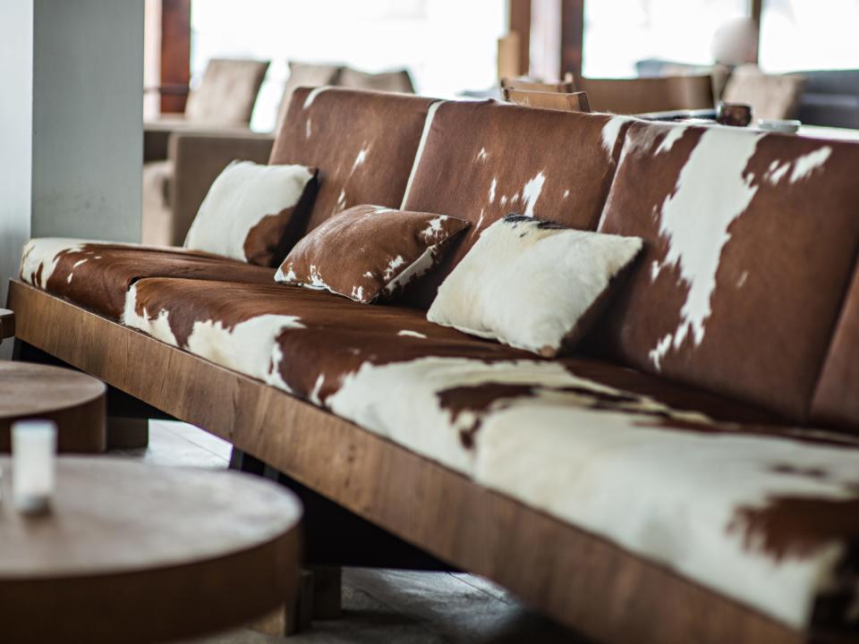 A brown-and-white cow print sofa