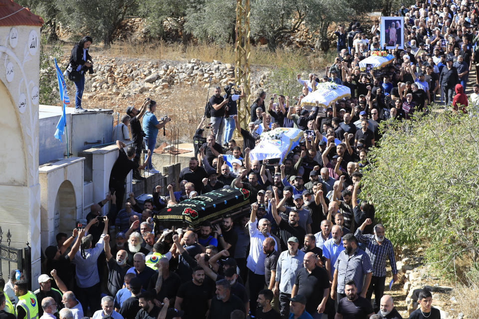 People carry the coffins of the victims killed by an Israeli airstrike, during their funeral procession in the town of Blida, a Lebanese border village with Israel in south Lebanon, Tuesday, Nov. 7, 2023. A Lebanese woman and her three grand daughters were laid to rest in their hometown in southern Lebanon two days after they were killed in an Israeli drone strike while in a car near the Lebanon-Israel border. (AP Photo/Mohammed Zaatari)