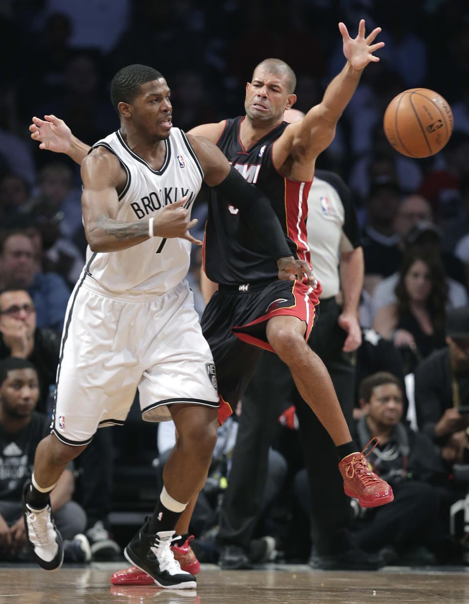 Brooklyn Nets guard Joe Johnson (7) passes the ball against Miami Heat forward Shane Battier in the second period during Game 3 of an Eastern Conference semifinal NBA playoff basketball game on Saturday, May 10, 2014, in New York. (AP Photo/Julie Jacobson)