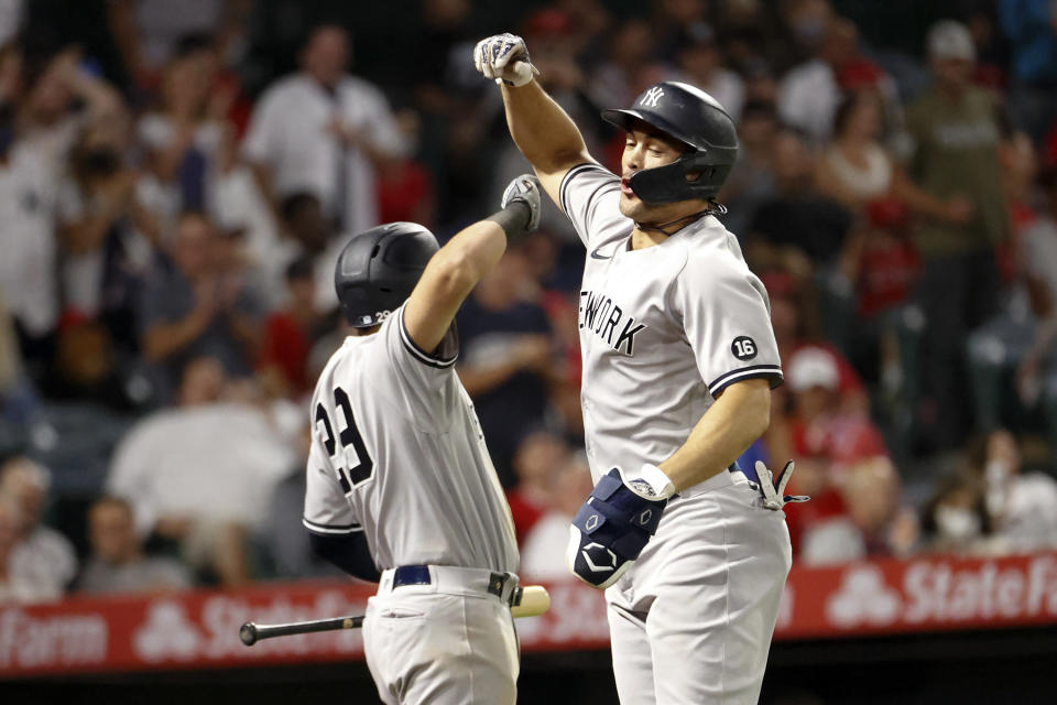 New York Yankees' Giancarlo Stanton, right, celebrates with Gio Urshela after hitting a two-run home run during the seventh inning of a baseball game against the Los Angeles Angels in Anaheim, Calif., Monday, Aug. 30, 2021. (AP Photo/Ringo H.W. Chiu)