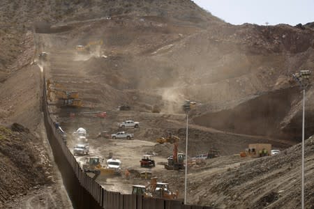 A general view shows a construction crew working on a bollard-type private border wall, crowd-funded by We Build The Wall group at Sunland Park, New Mexico, as pictured from Ciudad Juarez
