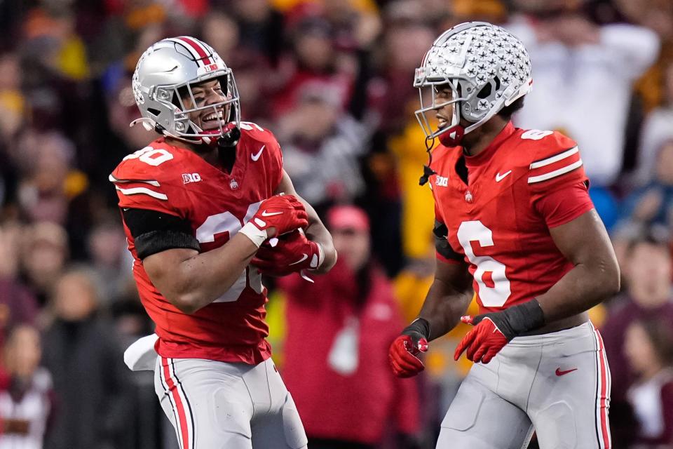 Nov 18, 2023; Columbus, Ohio, USA; Ohio State Buckeyes linebacker Cody Simon (30) celebrates a defensive stop on what was nearly an interception with safety Sonny Styles (6) during the NCAA football game against the Minnesota Golden Gophers at Ohio Stadium.