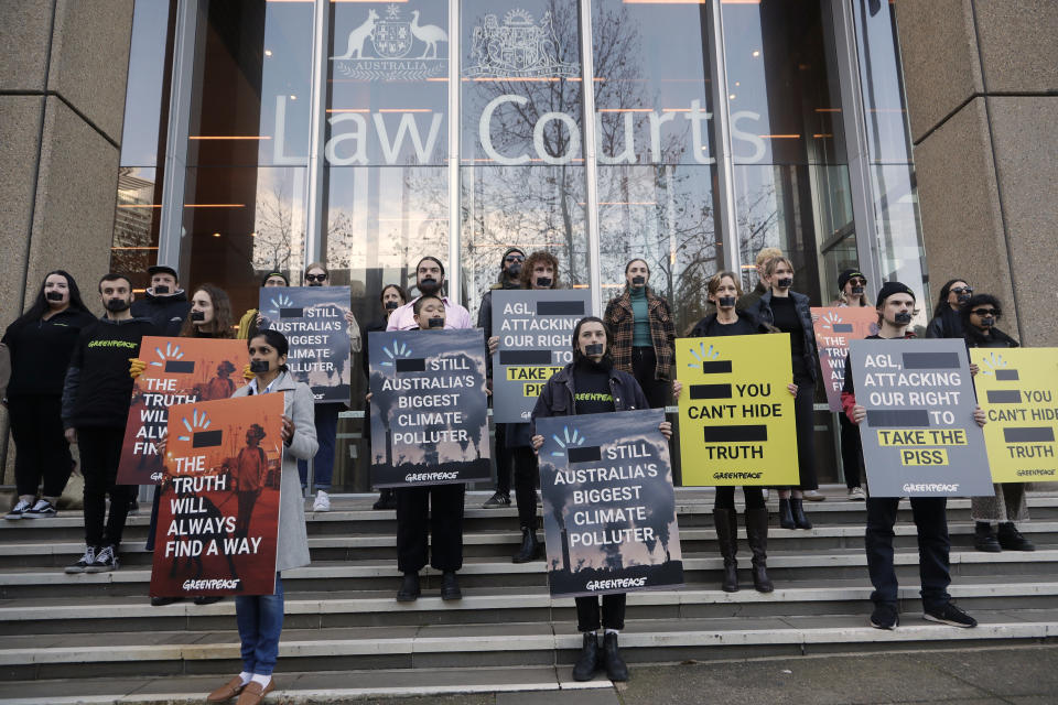 Greenpeace supporters demonstrate outside the Federal Court in Sydney, Wednesday, June 2, 2021. Australia's largest electricity generator AGL Energy is taking Greenpeace to court alleging breaches of copyright and trademark laws in the environmental charity's campaign that describes AGL as the nation's "biggest climate polluter." (AP Photo/Rick Rycroft)