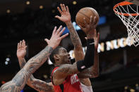 Houston Rockets' Kevin Porter Jr. (3) goes up for a shot as Memphis Grizzlies' Brandon Clarke defends during the first half of an NBA basketball game Sunday, March 6, 2022, in Houston. (AP Photo/David J. Phillip)