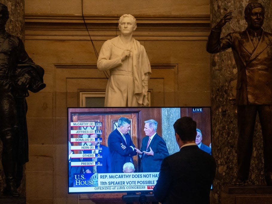 staffer watches CSPAN on a television monitor in Statuary Hall during the 10th attempt in the House to elect a speaker in the Capitol on Thursday, January 5, 2023.