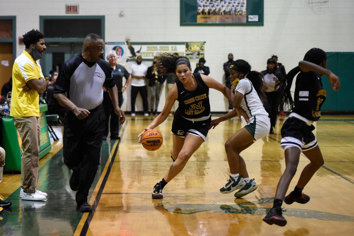 Cross Creek #23 Erin Martin dribbles the ball down the court during their game against Josey high school at T.W. Josey High School in Augusta on Friday, Nov. 19, 2021. 