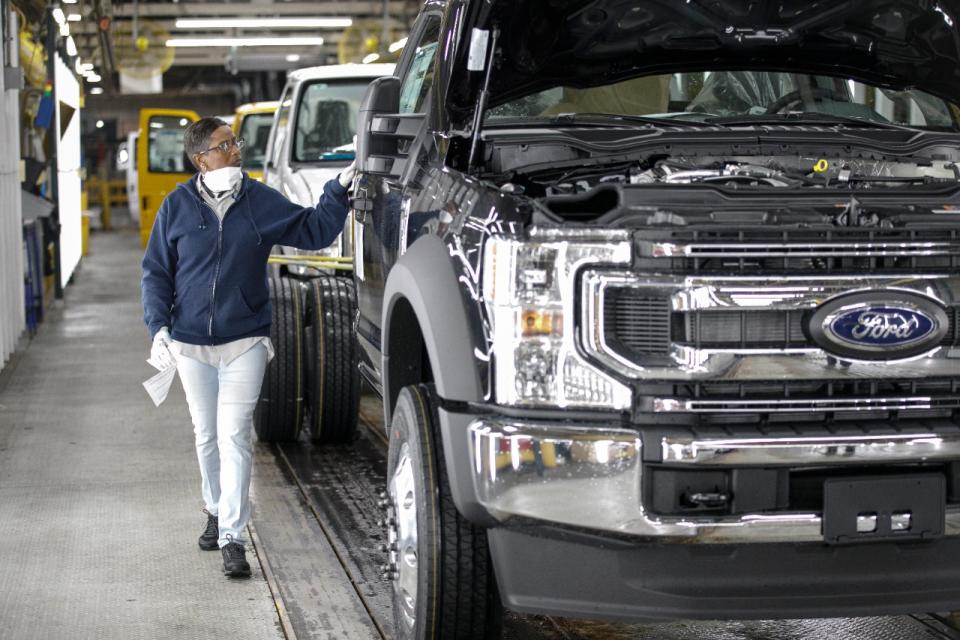 Worker operating a truck in a factory.