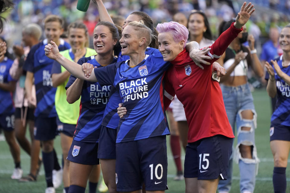 FILE - From left, OL Reign's Lauren Barnes, Jessica Fishlock and Megan Rapinoe celebrate after the Reign beat the Portland Thorns in an NWSL soccer match, Sunday, Aug. 29, 2021, in Seattle. Five players who helped launch the National Women's Soccer League in 2013 and are still with their same teams. The list also includes Tori Huster of the Washington Spirit and the OL Reign's Megan Rapinoe, Jess Fishlock and Lauren Barnes. (AP Photo/Ted S. Warren, File)