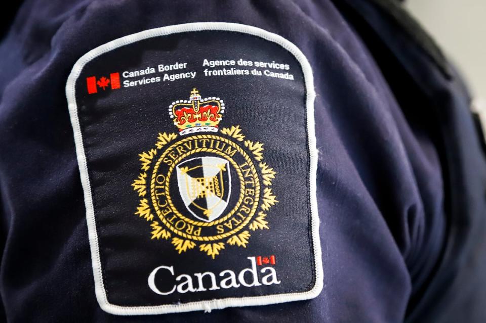 Canada Border Services Agency says it has seized more than 1,350 prohibited weapons and firearms linked to residences in Chilliwack, B.C. A CBSA patch is seen on an officer in Calgary on Aug. 1, 2019.