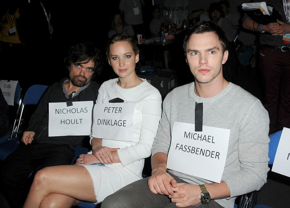 Jennifer and Nicholas sitting with Peter Dinklage and wearing each other's name tag