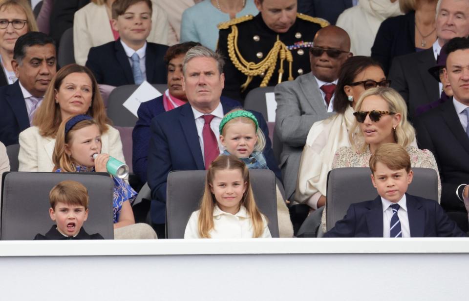 LONDON, ENGLAND - JUNE 05: (L-R 2nd Row) Victoria Starmer, Keir Starmer, Lena Tindall, Zara Tindall, (front row) Prince Louis of Cambridge, Princess Charlotte of Cambridge, and Prince George of Cambridge watch the Platinum Pageant on June 05, 2022 in London, England. The Platinum Jubilee of Elizabeth II is being celebrated from June 2 to June 5, 2022, in the UK and Commonwealth to mark the 70th anniversary of the accession of Queen Elizabeth II on 6 February 1952. (Photo by Chris Jackson - WPA Pool/Getty Images)