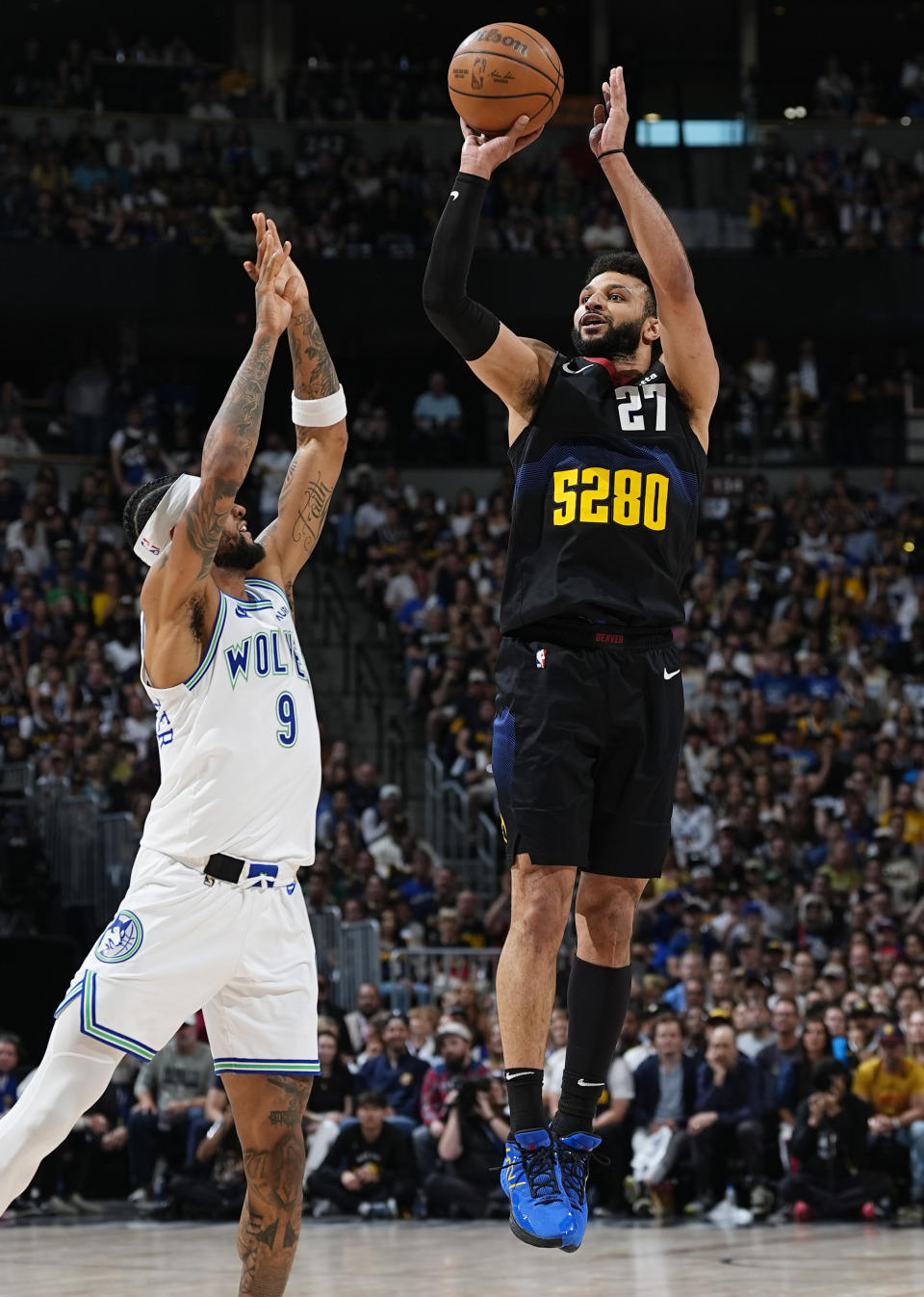 Denver Nuggets guard Jamal Murray, right, shoots over Minnesota Timberwolves guard Nickeil Alexander-Walker in the first half of Game 7 of an NBA second-round playoff series, Sunday, May 19, 2024, in Denver. (AP Photo/David Zalubowski)