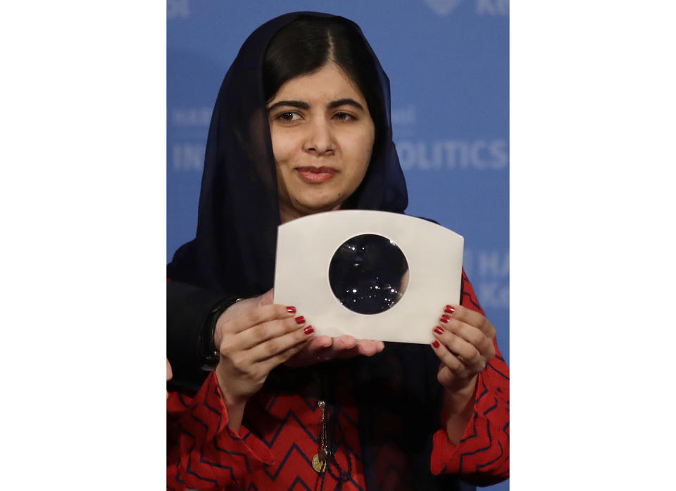 2014 Nobel Laureate Malala Yousafzai holds up the 2018 Gleitsman Activist Award while being honored prior to an address at the Kennedy School's Institute of Politics at Harvard University in Cambridge, Mass., Thursday, Dec. 6, 2018. (AP Photo/Charles Krupa)