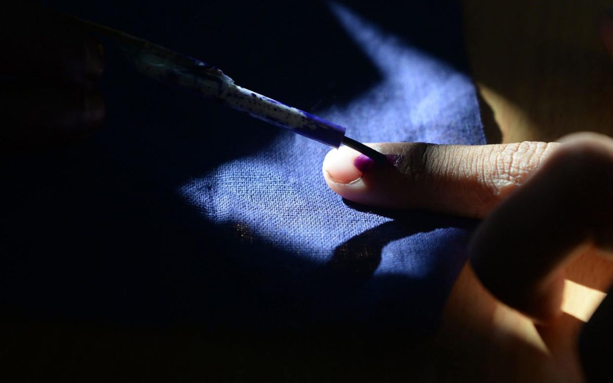  In this file photo taken an Indian voter gets his finger marked with ink as he votes at a polling station in Chennai - AFP