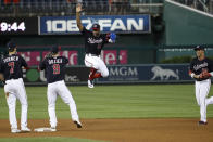 Washington Nationals' Victor Robles (16) jumps as he celebrates with Trea Turner, Brian Dozier and Juan Soto, right, after the team's baseball game against the Cincinnati Reds at Nationals Park, Tuesday, Aug. 13, 2019, in Washington. The Nationals won 3-1. (AP Photo/Alex Brandon)