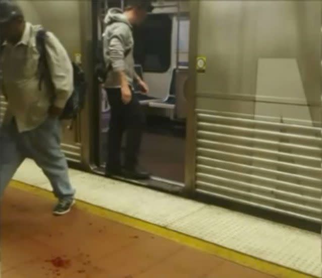 The two men in the video left the scene on a train before paramedics arrived. Blood can be seen on the ground. Image: KTLA