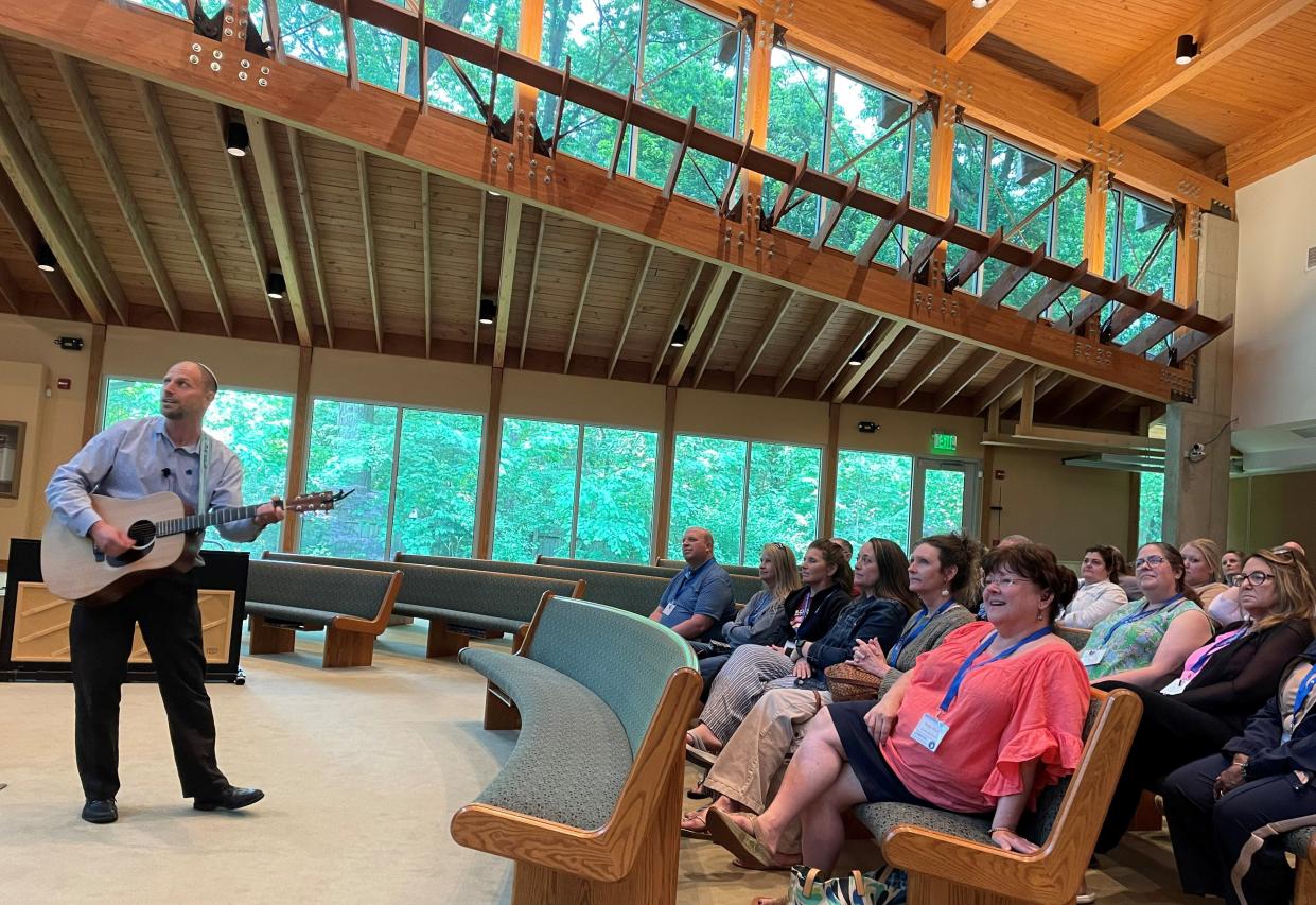 Rabbi Rick Kellner, of Congregation Beth Tikvah synagogue in Worthington, plays the guitar for K-12 teachers in June as part of a seminar on how to teach the Holocaust.