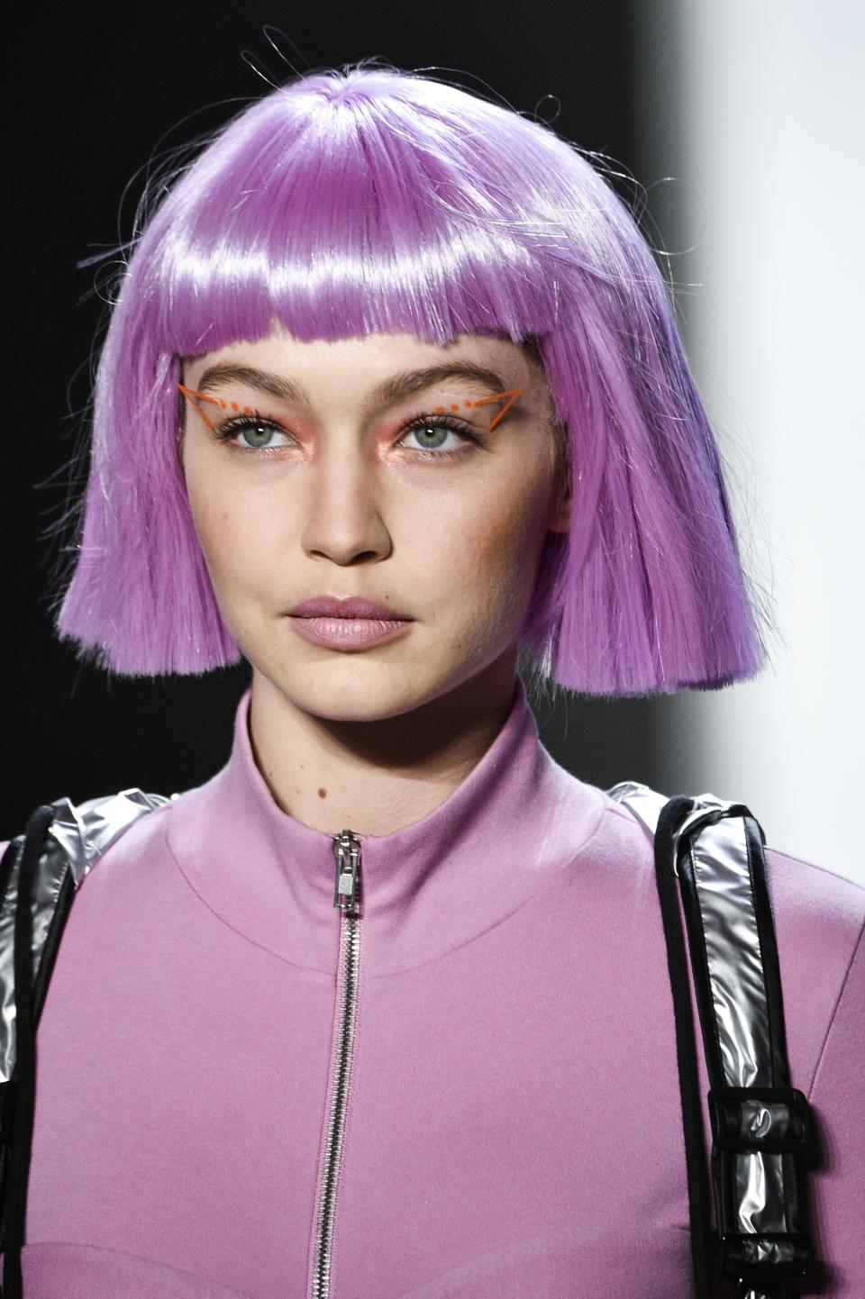 Gigi Hadid walked the runway at Jeremy Scott’s Fall 2018 show on the first day of New York Fashion Week on Thursday with hot pink hair.