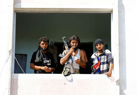 Members of Turkish-backed Free Syrian Army (FSA) are pictured as they look out from a building in the border town of Jarablus, Syria, August 31, 2016. REUTERS/Umit Bektas