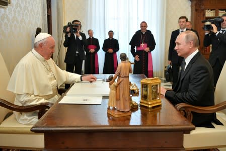 Russian President Vladimir Putin meets Pope Francis at the Vatican