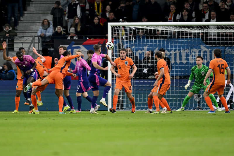 Germany's Niclas Fuellkrug (C) scoes his side's second goal of the game during the International Friendly soccer match between Germany and Netherlands at the Deutsche Bank Park stadium. Arne Dedert/dpa