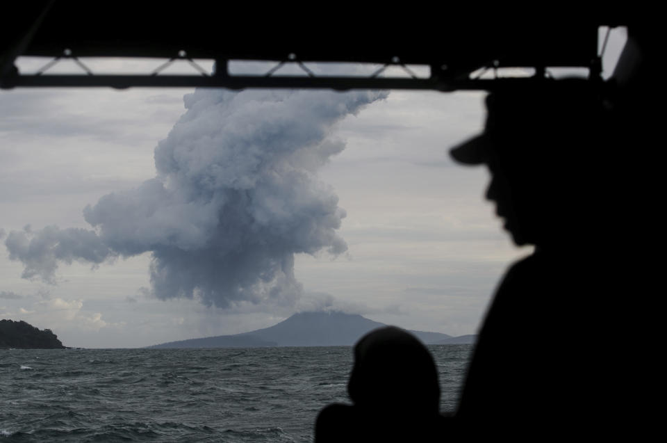 FILE - In this Dec. 28, 2018, file photo, Indonesian Navy personnel watch as Mount Anak Krakatau spews volcanic materials during an eruption in the waters of Sunda Strait. (AP Photo/Fauzy Chaniago, File)