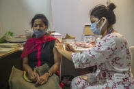 A woman receives Covishield COVID-19 vaccine at a vaccination center in Mumbai, India, Thursday, Sept. 23, 2021. (AP Photo/Rafiq Maqbool)