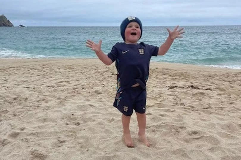 A three-year-old tot wowed a beach with his God Sav the King rendition