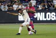 Los Angeles FC forward Carlos Vela, left, is defended by Dallas FC defender Nkosi Burgess during the first half of an MLS soccer match Wednesday, June 23, 2021, in Los Angeles. (AP Photo/Marcio Jose Sanchez)