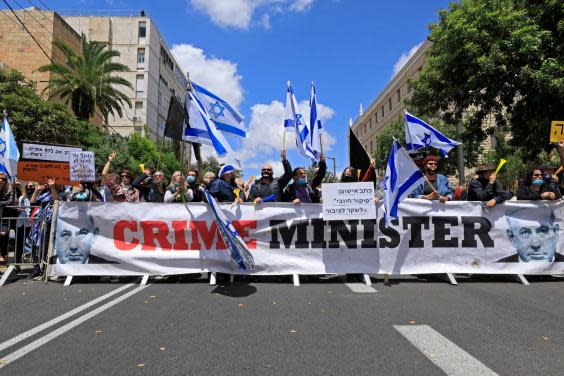 Israeli protesters rally against Prime Minister Benjamin Netanyahu outside his residence in Jerusalem (EMMANUEL DUNAND/AFP via Getty Images)