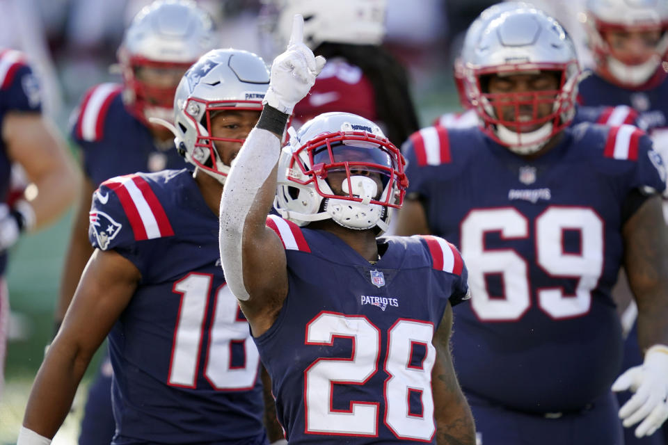 New England Patriots running back James White, center, celebrates his touchdown run against the Arizona Cardinals in the first half of an NFL football game, Sunday, Nov. 29, 2020, in Foxborough, Mass. (AP Photo/Elise Amendola)