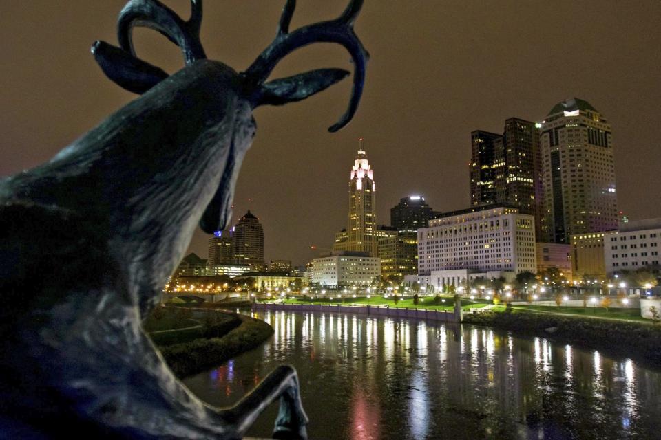 A buck sculpture by Terry Allen overlooks the Scioto River and Columbus Skyline on the Rich Street Bridge on Sunday, Nov. 12, 2017.