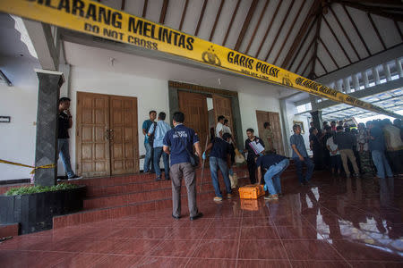 Police are seen outside the Lidwina Catholic Church after a knife-wielding attacker wounded four church-goers in Sleman, Yogyakarta, Indonesia February 11, 2018 in this photo taken by Antara Foto. Antara Foto/Andreas Fitri Atmoko/ via REUTERS