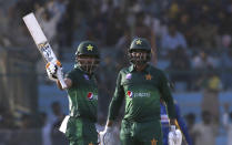 Babar Azam, left, acknowledges his fifty against Sri Lanka with Haris Sohail, in Karachi, Pakistan, Monday, Sept. 30, 2019. Pakistan play a second one-day international after winning the toss and elected to bat against Sri Lanka. (AP Photo/Fareed Khan)