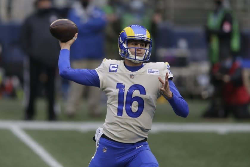 Rams quarterback Jared Goff looks to pass against the Seattle Seahawks during a playoff game Jan. 9, 2021, in Seattle.