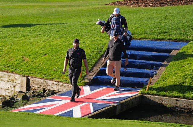 Tyrrell Hatton walks across a Union Flag bridge