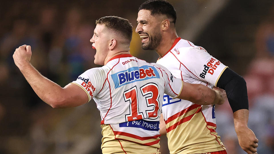 Dolphins players Tom Gilbert and Jesse Bromwich celebrate an NRL win.