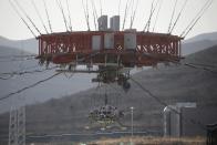 Lander is hanged for a hovering-and-obstacle avoidance test for China's Mars mission at a test facility in Huailai