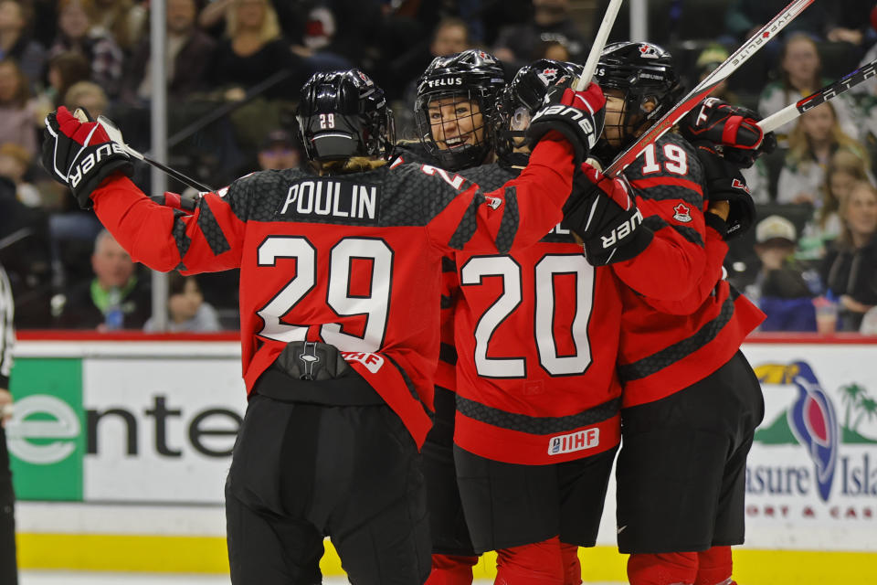 Canada players celebrates after a goal by Natalie Spooner (24) against the United States in the first period of a women's Rivalry Series hockey game Sunday, Feb. 11, 2024, in St. Paul, Minn. (AP Photo/Bruce Kluckhohn)