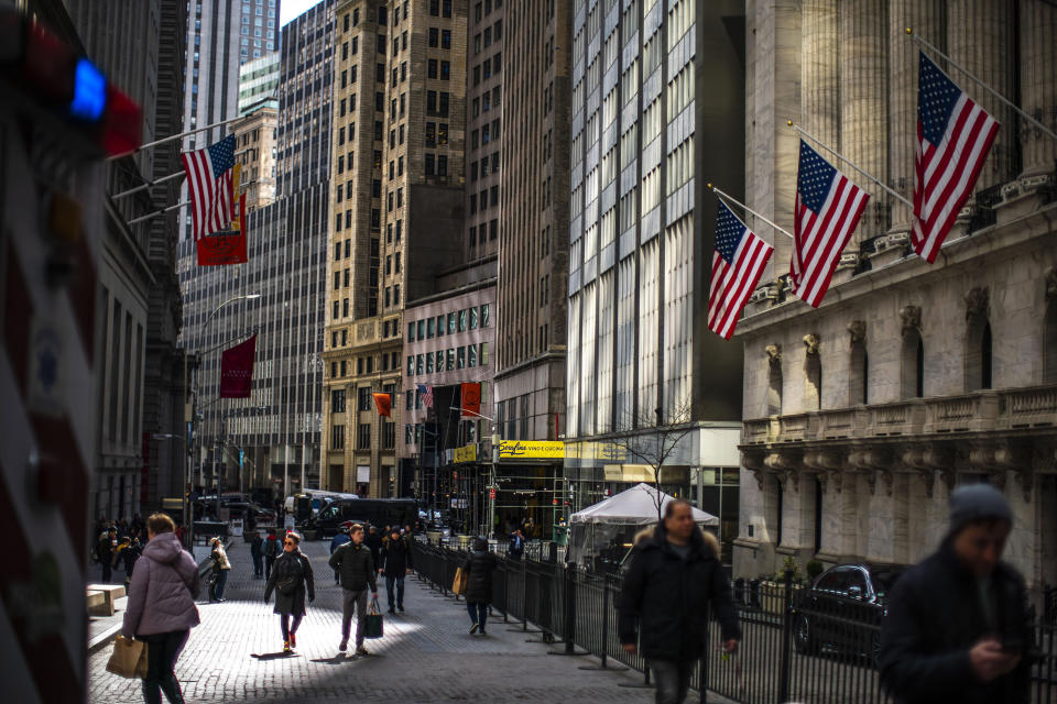 FILE - People walk past the New York Stock Exchange in New York on March 19, 2024. Global shares are mostly higher as investors looked ahead to earnings reports from top global companies and a consumer prices report that will be a gauge for U.S. inflation. (AP Photo/Eduardo Munoz Alvarez, File)