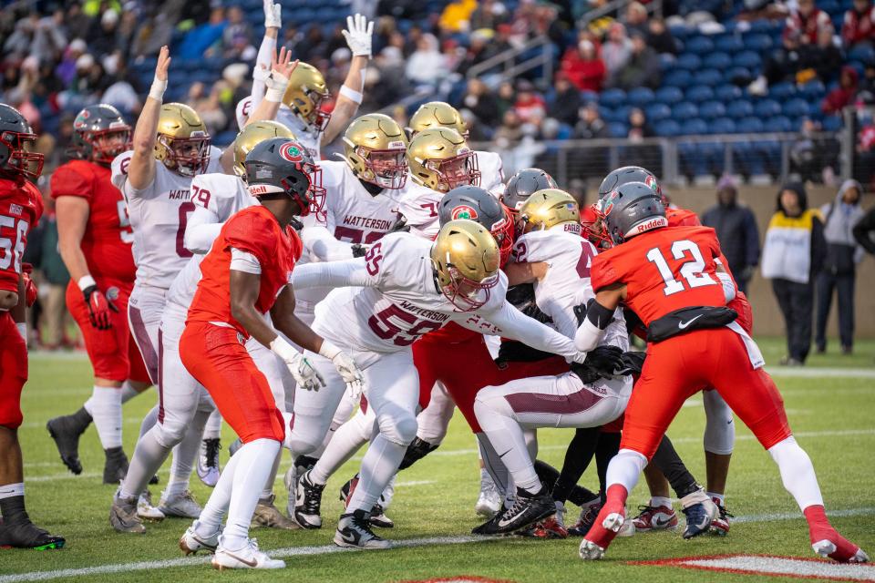 Watterson pushes Ben Uhlenhake into the end zone for the first touchdown in Friday's Division III state final against Toledo Central Catholic at Tom Benson Hall of Fame Stadium in Canton.